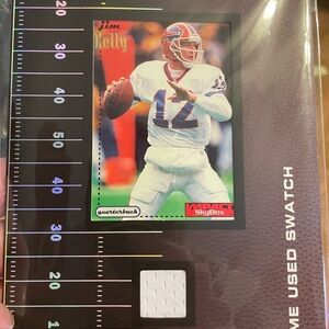 Game used swatch display ft. Jim Kelly Qb of the Buffalo Bills. Display is 5x7
